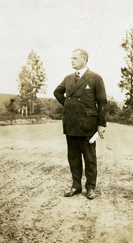 Governor Angus Wilton McLean, standing on an unpaved road, 1925-1929. Image from the North Carolina Museum of History.