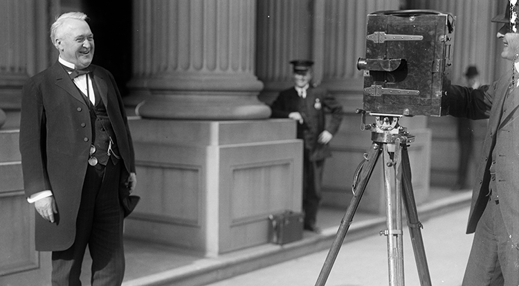 Senator Lee Slater Overman smiling for a movie camera in 1914. Image from the Library of Congress.
