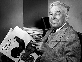 Photograph of Clarence Hamilton Poe posing with the 75th anniversary edition of Progressive Farmer (1956). Image from the Special Collections Research Center at the North Carolina State University Libraries.