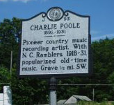 Charlie Clay Poole's mile marker located at NC 14 at SR 1700 (Fisher Hill Road) northwest of Eden in Rockingham County. Presented on North Carolina Highway Historical Marker Program.