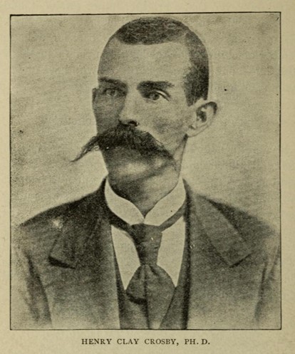 Crosby is facing right wearing a three-piece suit and tie. He has short hair and a thick, prominent moustache.