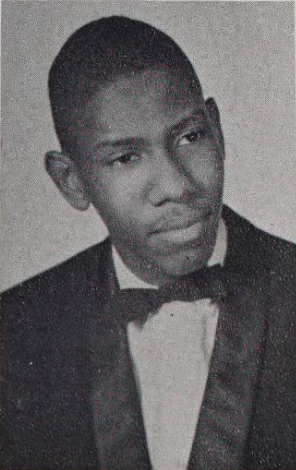 A formal headshot of Talley as a teen. He is wearing a tuxedo. He has a slight smile and short hair.