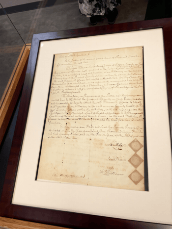 A frame document. It is written in cursive and looks important.