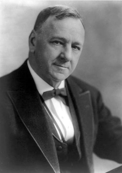 Photo of Josephus Daniels. He has short hair and is wearing a suit.