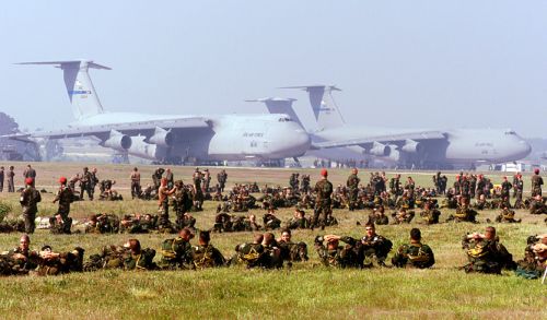" 	   Soldiers of the U.S. Army's 82nd Airborne Division relax at Pope Air Force Base, N.C., prior to loading into aircraft for an airdrop on May 7, 2000." Image courtesy of the U.S. Department of Defense.