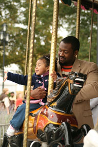 Father and daughter on carousel at the State Fair. Image courtesy of the NC State Fair: http://www.ncstatefair.org/