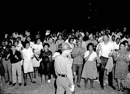 African American protesters chanting and clapping on the lawn of the Executive Mansion in Raleigh, North Carolina (1963)