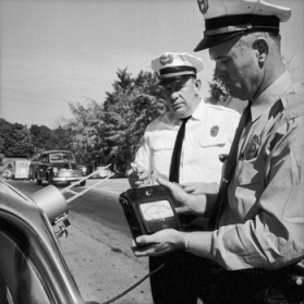 Chapel Hill police officers calibrating a speed-detection device in 1961. Photograph by Roland Giduz. North Carolina Collection, University of North Carolina at Chapel Hill Library.