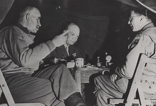 "General Wyche (right) lunches with Gens. Bradley and Eisenhower in Normandy, less than a month after the Allied invasion". 1944. Image courtesy of ECU Libraries. 
